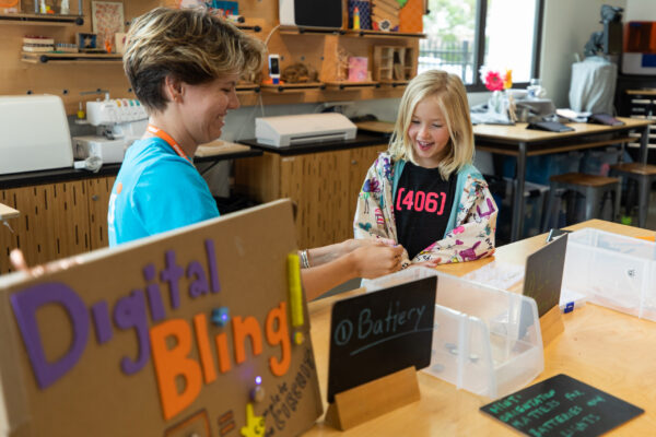 First Floor_IWS_Createch_Spark assisting girl with Digital Bling activity
