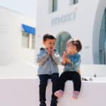 Toddlers sitting outside MOXI.